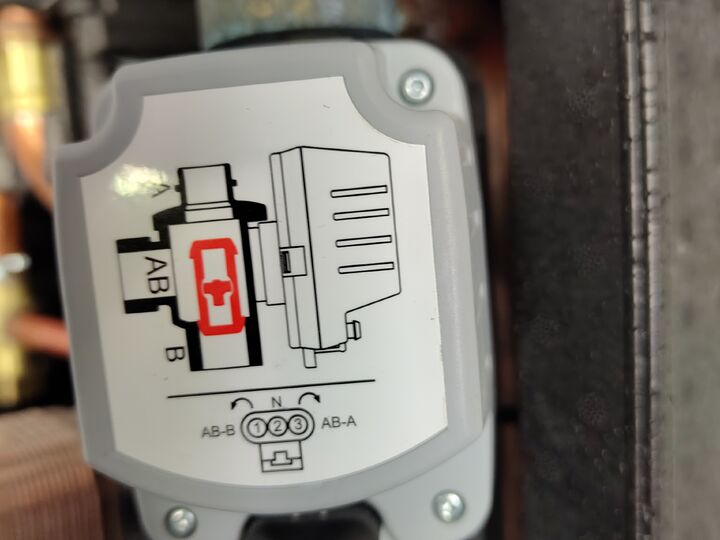 Motorized changeover valve actuator. Open enclosure · lower-left.