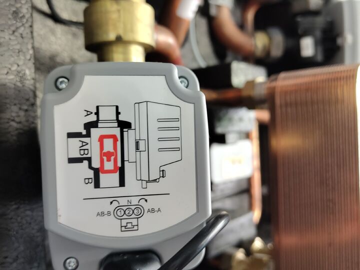 Second motorized changeover valve actuator. Open enclosure · upper-right.