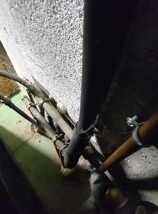 Installed hot-water outlet C toward house distribution. Floor-level trace.