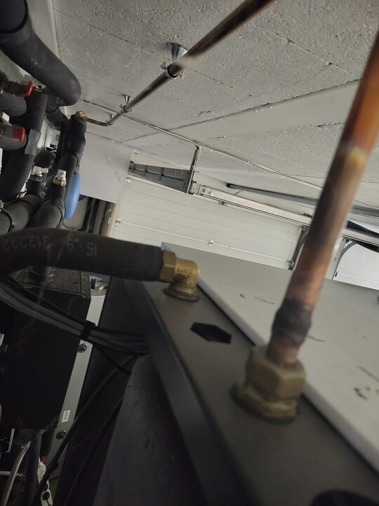 DHW hot outlet C and adjacent cold/safety route. Top heat-pump connections.