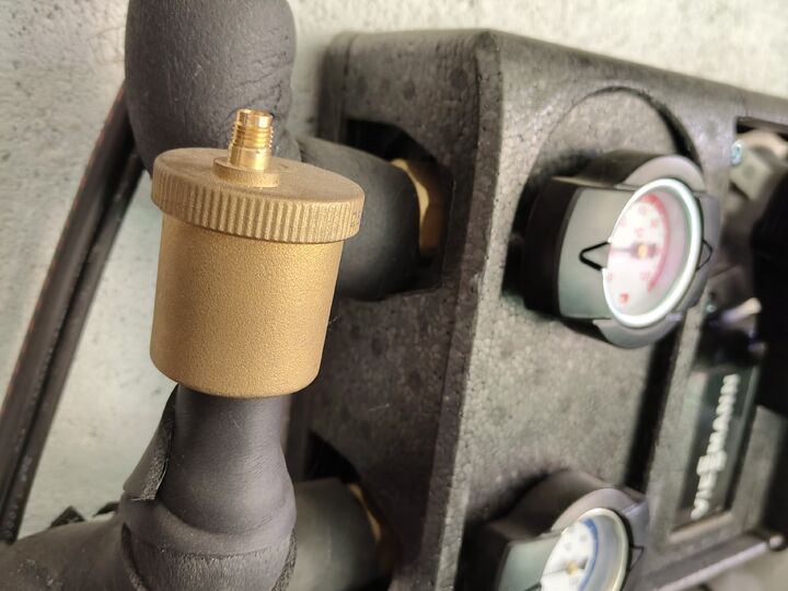 Brass automatic air vent beside secondary group. Left piping · close-up.