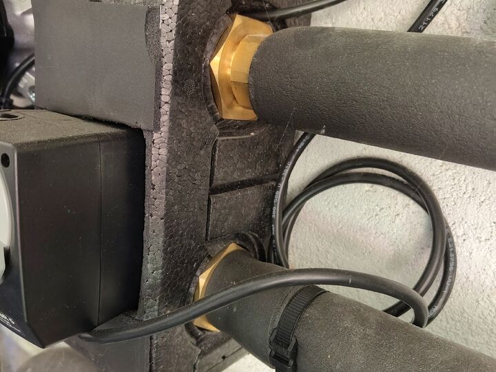 Two brass unions at rear of insulated group. Rear/right side · close-up.