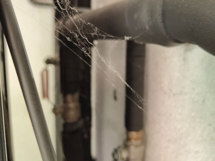 Partly obscured insulated pipe run. Behind equipment · restricted view.